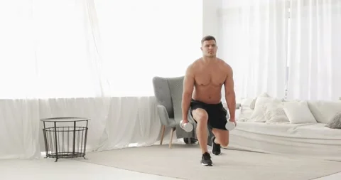 Athletic man with naked torso is doing lunge squat exercise at home, front view. Stock Footage 143849505