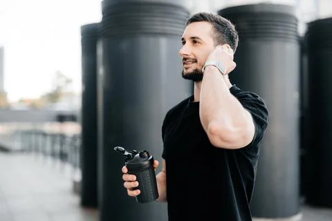 Athletic man pauses training to answer the call. Friendly man talking on the Stock Photos