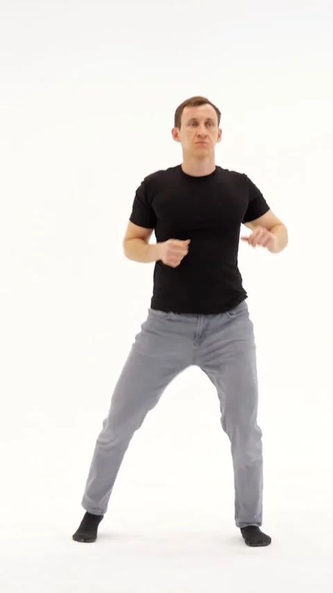 Athletic Man Performs Dynamic Choreography Across Bright Studio Background Stock-Footage 346989217