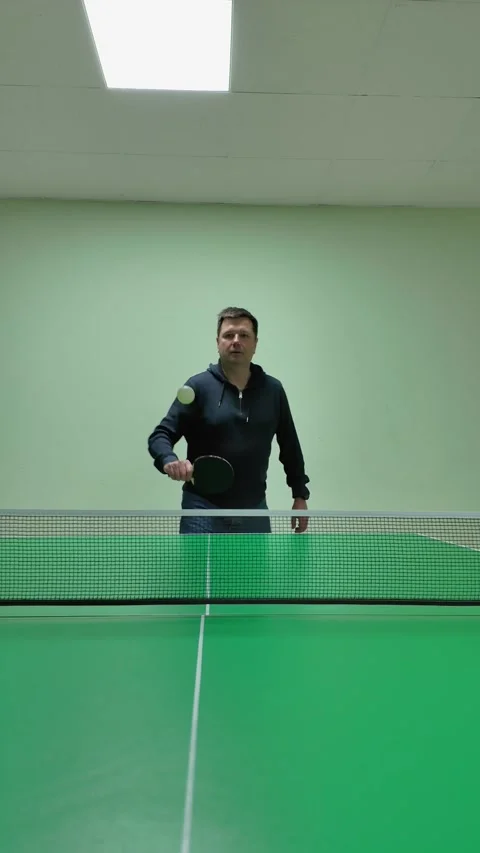 Athletic Man Playing Table Tennis Captured in Dynamic Low-Angle Vertical Vide Stock Footage 301516423