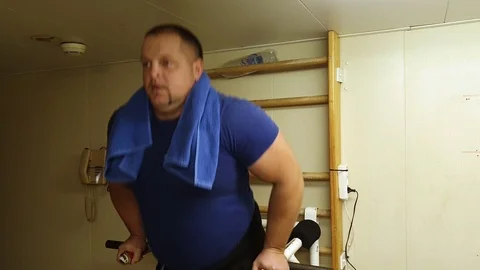 Athletic man practices triceps exercises on special machine Stock Footage 118358282