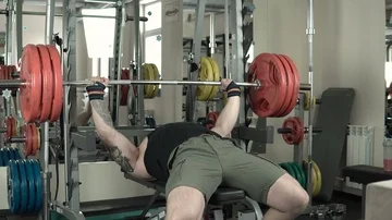 Athletic man practicing with a barbell close-up 4k. Stock Footage 85588884