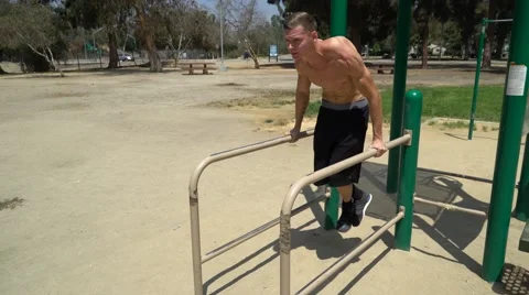 Athletic man practicing on the horizontal bar street Stock Footage 66434990