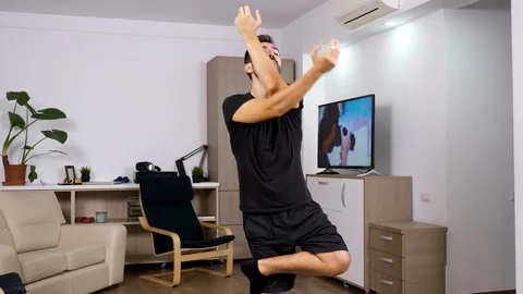 Athletic man practicing yoga at home Stock Footage 95641166