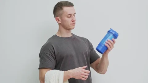 Athletic man prepares protein shake after workout. Stock Footage 127495394