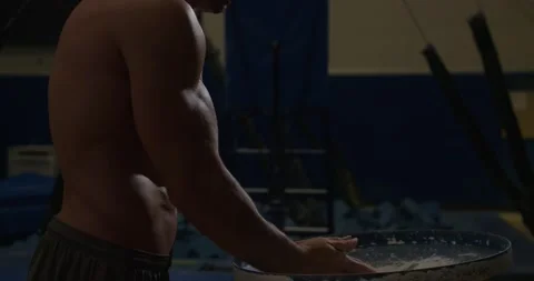 Athletic man preparing hands with chalk for Olympic Rings in gym Video stock 132207653