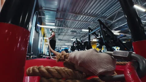 Athletic Man Preparing For Rope Pulling Weighted Sled Along Gym Training Track Stock Footage 336279677