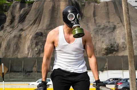 Athletic man in a protective mask at practice in the morning. Stock Photos