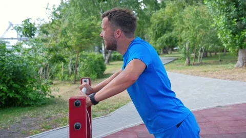 Athletic man pull up on a horizontal bar in the park on the playground. Stock Footage 138919674