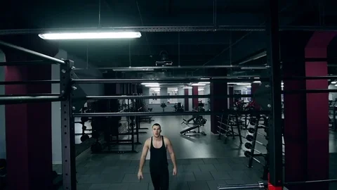 Athletic man pulling up on horizontal bar in fitness gym slow Stockbeeldmateriaal 74107924