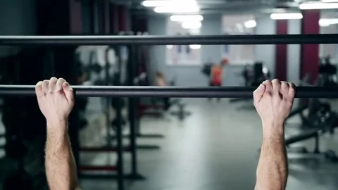 Athletic man pulling up on horizontal bar in fitness gym slow Stock Footage 74108128