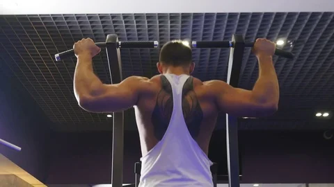 Athletic Man Pulling up on Horizontal Bar in Fitness Gym Stock Footage 75348496