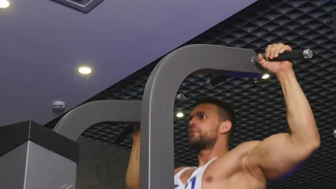 Athletic Man Pulling up on Horizontal Bar in Fitness Gym Stock Footage 75348796