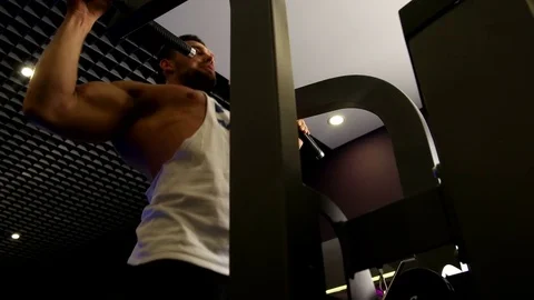 Athletic Man Pulling up on Horizontal Bar in Fitness Gym Stock Footage 75368228