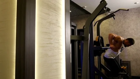 Athletic Man Pulling up on Horizontal Bar in Fitness Gym Stock Footage 75368634