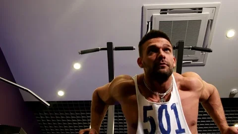 Athletic Man Pulling up on Horizontal Bar in Fitness Gym Stock Footage 75369073