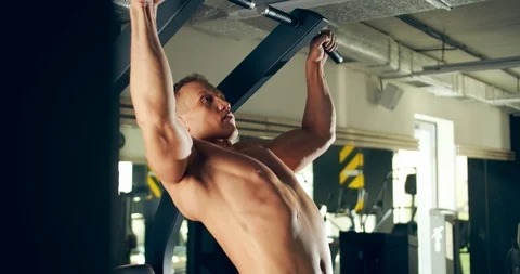 Athletic man pulls up in the gym hard working Видео 126559517