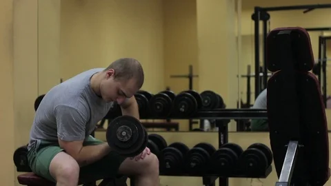 Athletic man pumping up muscles and drinking from the shaker Stock Footage 70394336