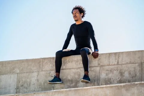 Athletic man relaxing after work out outdoors. Stock Photos