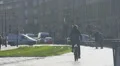 Athletic man riding bicycle near trolley tracks, city traffic, transportation HD Footage