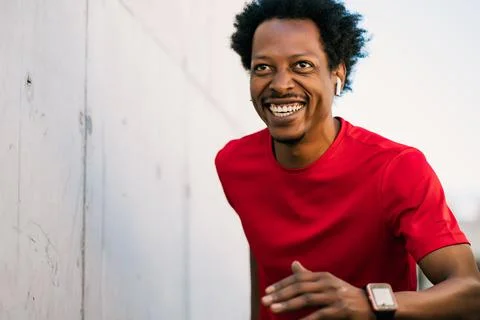 Athletic man running and doing exercise outdoors. Stock Photos