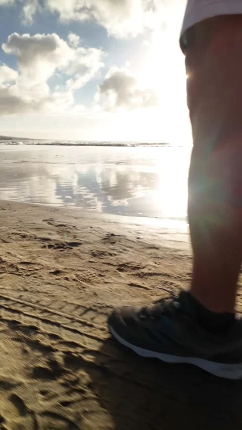 Athletic man running on the beach at sunrise Stock Footage 346177712