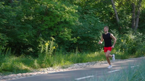 Athletic man running in park in slow motion Stock Footage 159131884