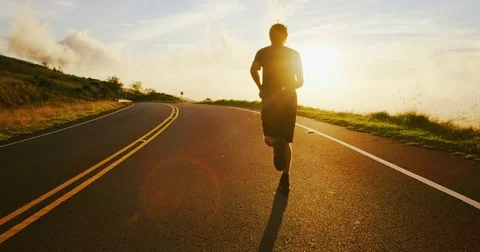 Athletic Man Running at Sunset Stock Footage
