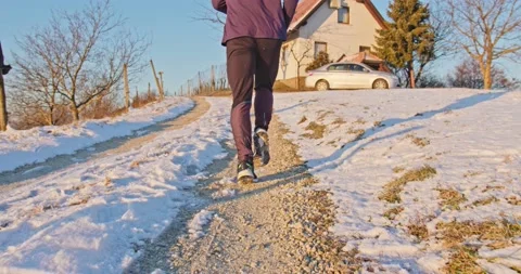 Athletic man Is Running Through The Snow - slow motion Stock Footage 146536556
