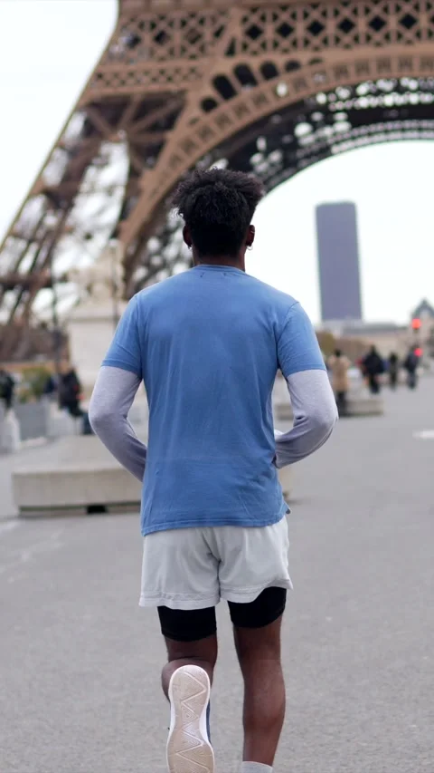 Athletic man running toward eiffel tower in paris Stock Footage 327456901