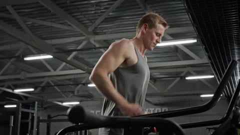 Athletic Man Running on Treadmill for Cardio Training in Gym Stock Footage 339879648