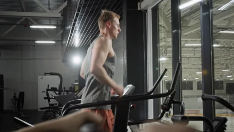 Athletic Man Running on Treadmill for Cardio Training Stock Footage 339893574
