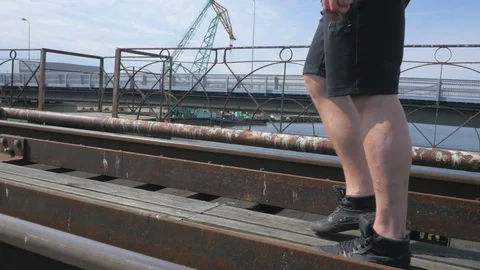Athletic man shoes close up during running on the bridge Video stock 84004456
