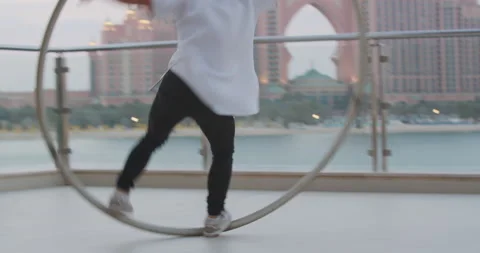 Athletic man is spinning in a wheel, stepping and spinning, tricks, gymnastics Stock Footage 151694067