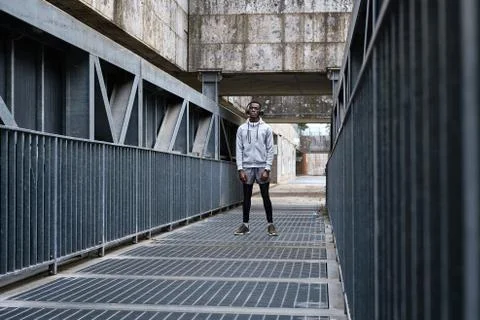 Athletic man is standing on the bridge Stock Photos