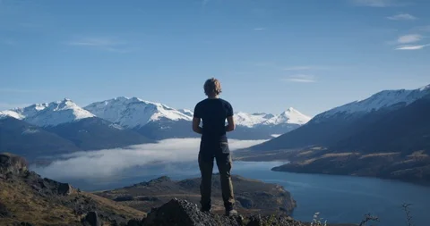 Athletic man at summit with panoramic view Stock Footage 90405138