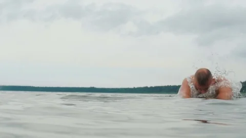 Athletic man swims making splashes. Slow motion close up Video stock 83818733