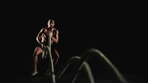 Athletic man training with battle ropes Stock Footage 151639665