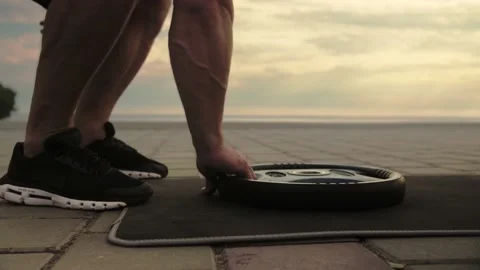 Athletic man training outdoors lifting weights with his hands.Close-up Stock Footage 200117657