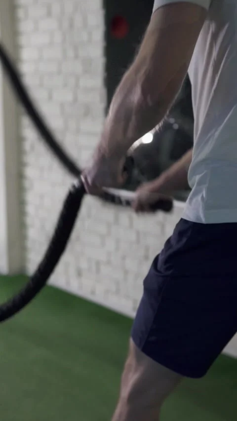 Athletic man training with ropes during crossfit workout in gym. Stock Footage 302806591