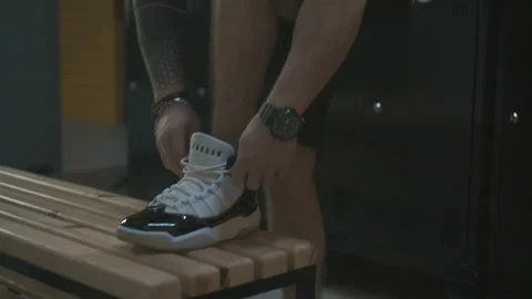 Athletic Man Tying Shoelaces Before A Workout In A Gym Locker Room Video stock 150509896