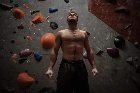 Athletic man using chalk before climbing in a bouldering gym Stock Photos