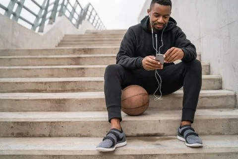 Athletic man using his mobile phone. Stock Photos