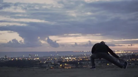 Athletic man warming up and stretching before outdoor morning workout Stock Footage 149392805