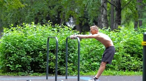 Athletic man warming up in City Park. side view. Workout Stock Footage 66420702