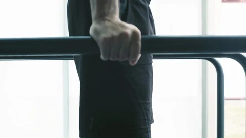 Athletic man working out on dip bars at the gym Stock Footage 127436870