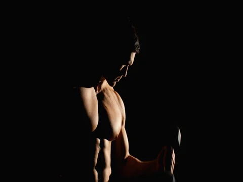 Athletic man working out with dumbbells in gym black background Stock Footage 75151771
