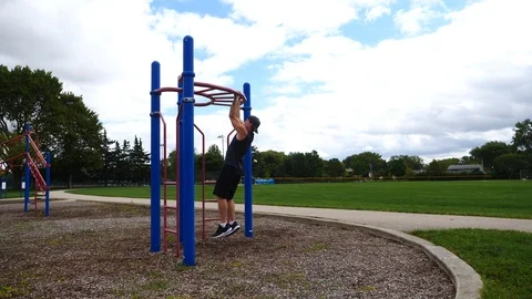 Athletic man working out training exercising doing pull ups, 4k, 60fps. Stock Footage 115900544
