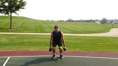 Athletic man working out training exercising dumbbell squats, 4k, 60fps. Stock Footage 115914460