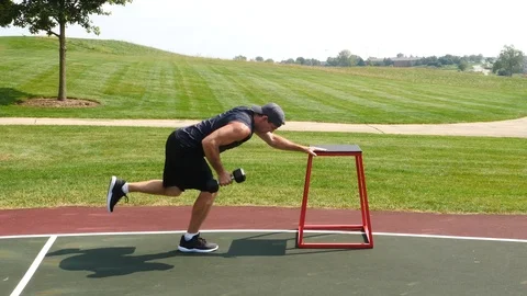 Athletic man working out training exercising 1 leg dumbbell rows, 4k, 60fps. Stock Footage 115914472